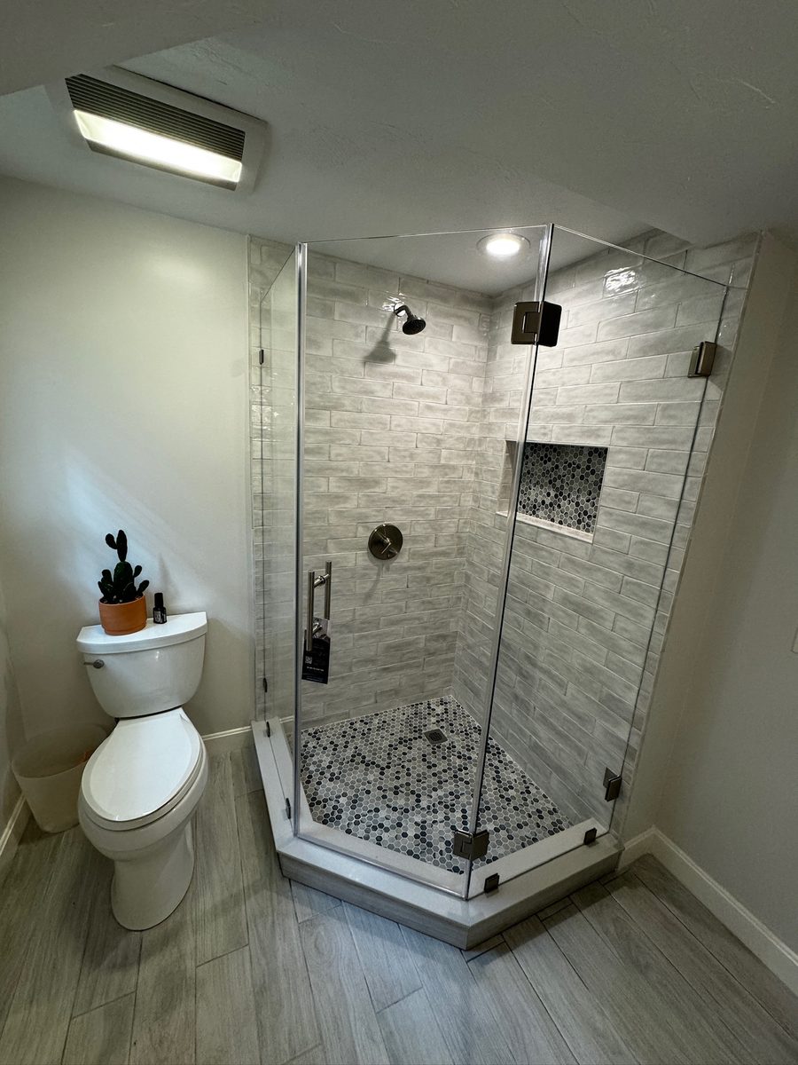 Frameless alcove shower door Needham MA brushed nickel pebble floor